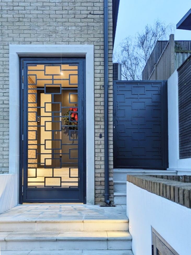 Bespoke black security door with geometric fretwork design, London property
